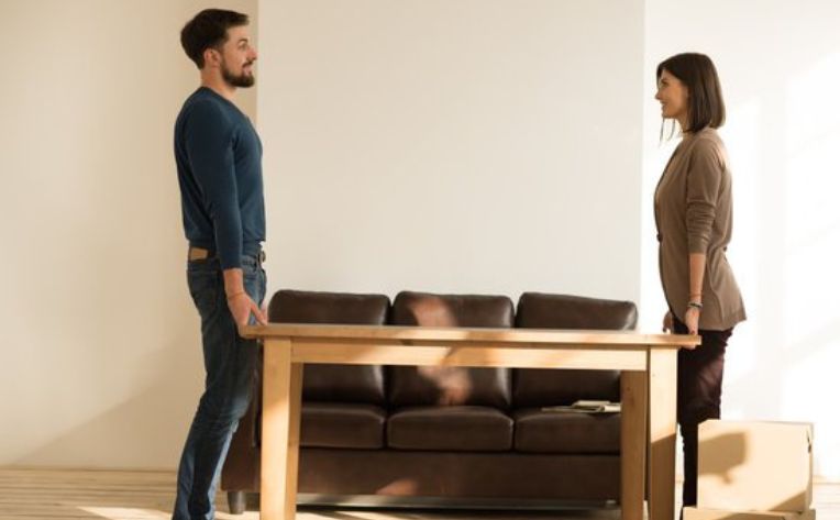 Couple moving furniture